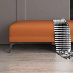 Functional black footstool at the foot of a sofa