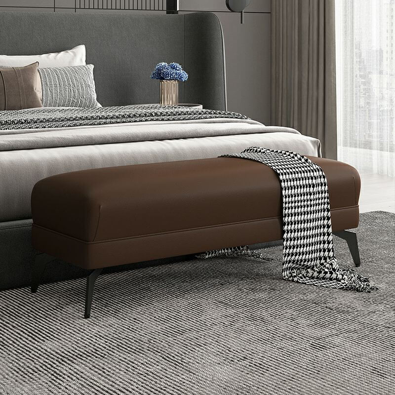 Functional black footstool at the foot of a sofa