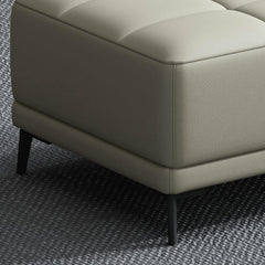 Grey rectangular footstool next to a sofa