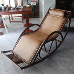 Cozy reading nook with a brown wicker rocking armchair