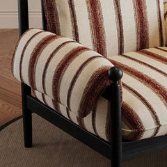 Upholstered cushioned chair with modern appeal