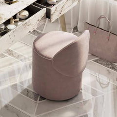 Contemporary pink armless vanity stool from a side angle