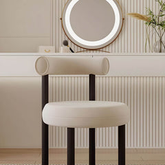 Chic metal framed vanity stool against a stylish backdrop