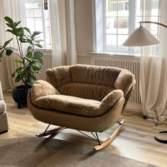 brown upholstered rocking chair indoors