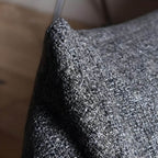 Bean bag chair surrounded by soft pillows