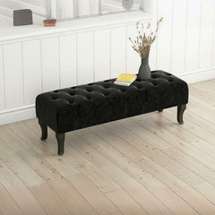 Black-legged ottoman in stylish interior