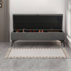 Black legs of a large storage ottoman