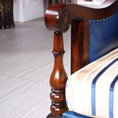 Sofa with sloped arms and nailhead details