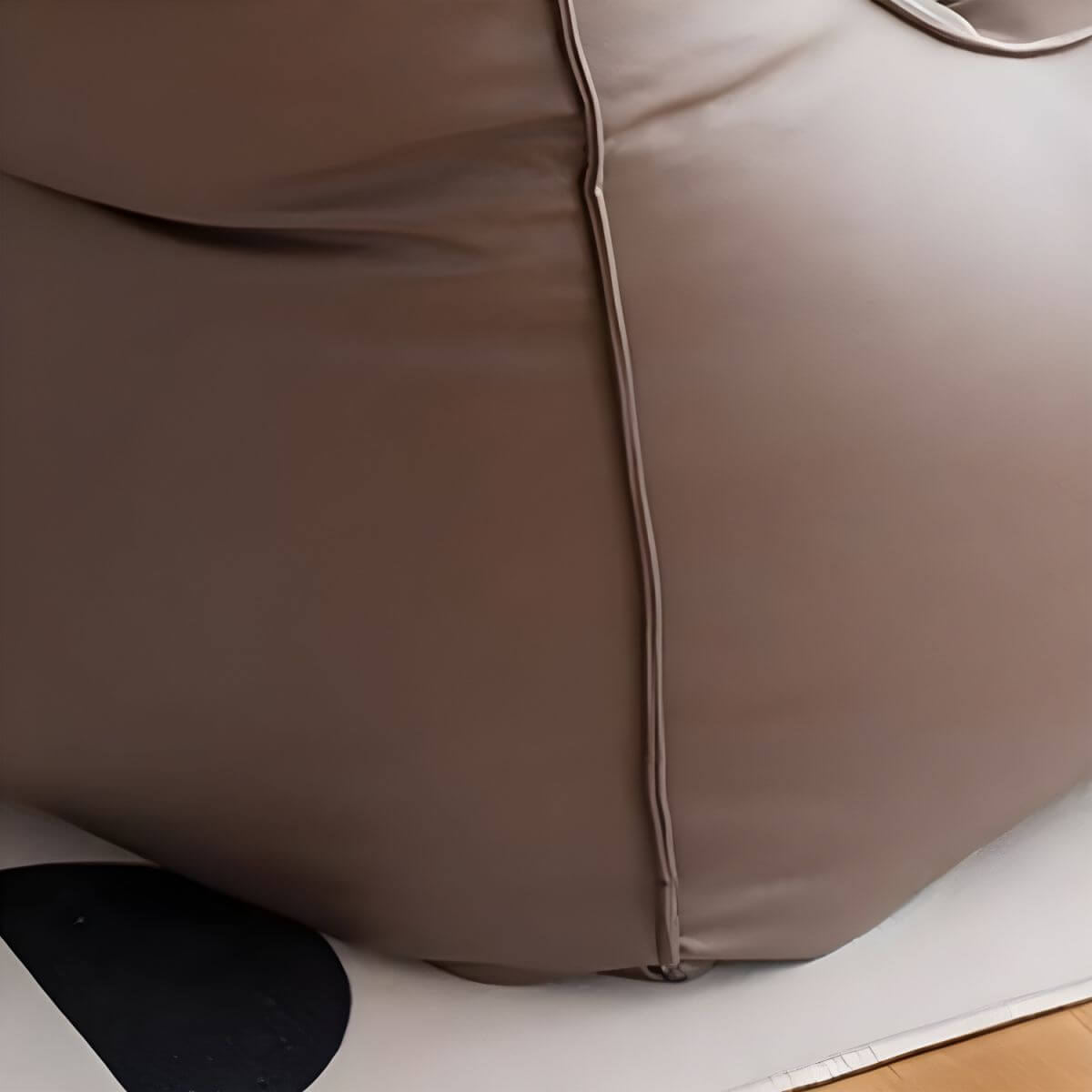 A person enjoying the comfort of a large bean bag chair