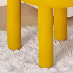 Yellow upholstered vanity stool adding a pop of color