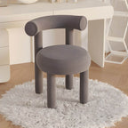 Lake blue upholstered vanity stool positioned beside modern vanity