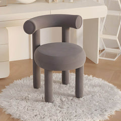 Lake blue upholstered vanity stool positioned beside modern vanity