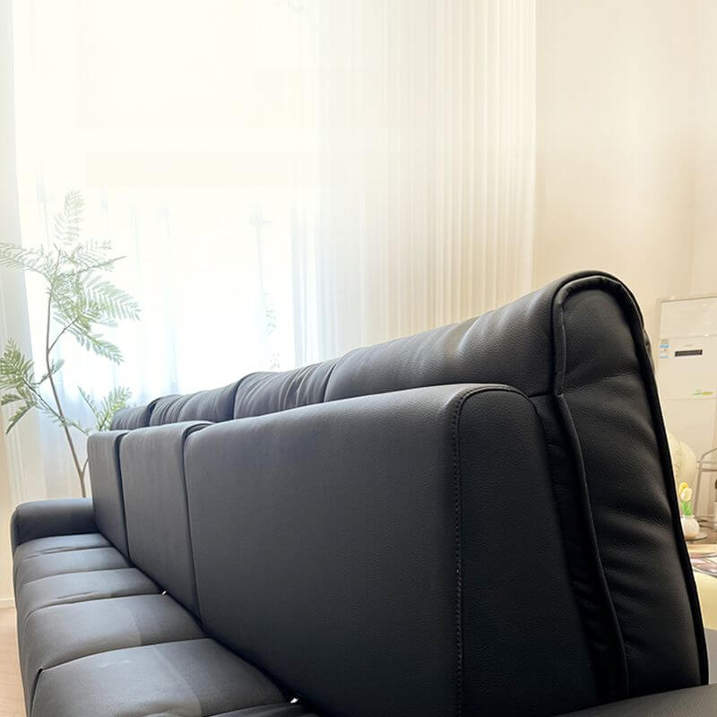 Sleek ink upholstered sofa against a light wall