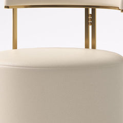 Set of two gold upholstered vanity stools on display