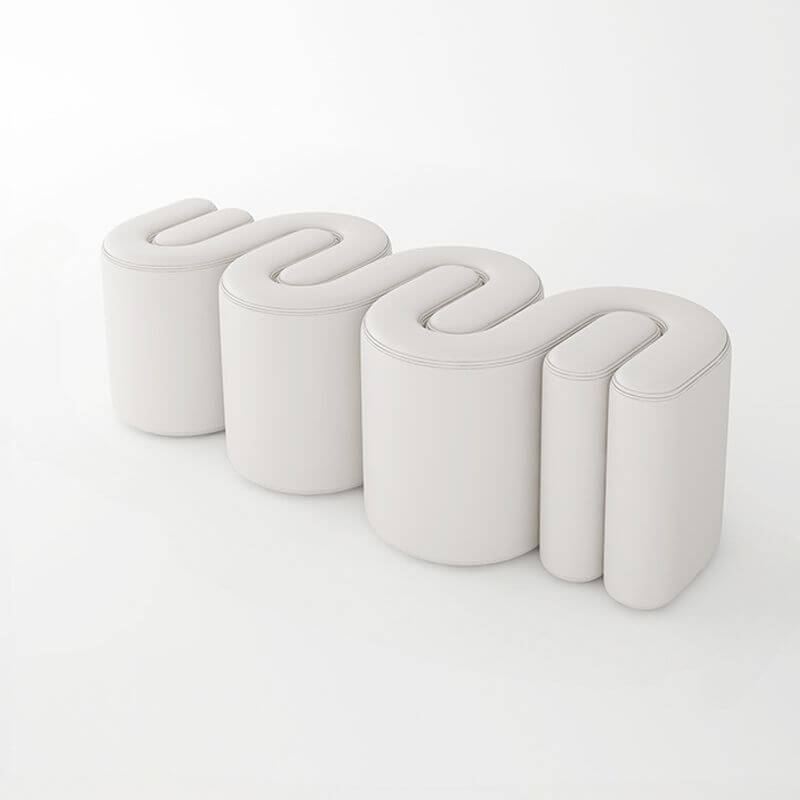 Blue upholstered stool against modern backdrop