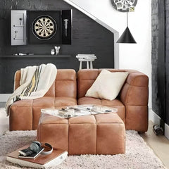 Modern upholstered brown accent stool in living room setting