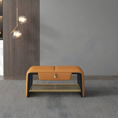 Modern gray storage ottoman placed at the foot of the bed