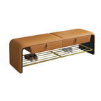 Modern gray storage ottoman placed at the foot of the bed