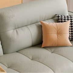 Pale grey upholstered sleeper with armrests