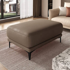 Side view of gray leather ottoman with sponge cushion