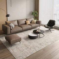 Leather upholstered sofa with pillows