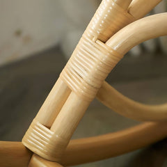 Person relaxing in the rattan rocking chair