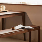 Stylish walnut wood bench against neutral backdrop