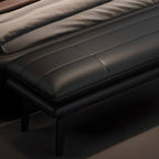 Long upholstered bench chair stylishly placed at the foot of the bed