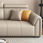 Three decorative pillows on a grey sofa