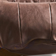 Detail view of the sewn pillow back of the armchair