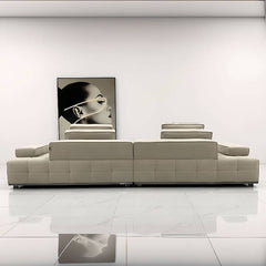 Modern sofa with three decorative pillows in a living room setting