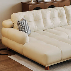 Plush pillows on a white floor sofa