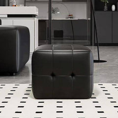 Decorative-stitched pouf on carpet
