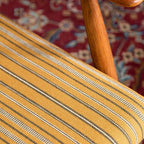 Yellow accent chair beside a bookshelf