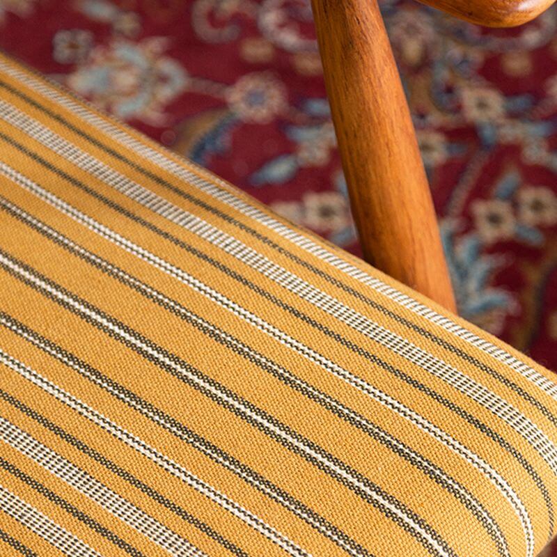 Yellow accent chair beside a bookshelf