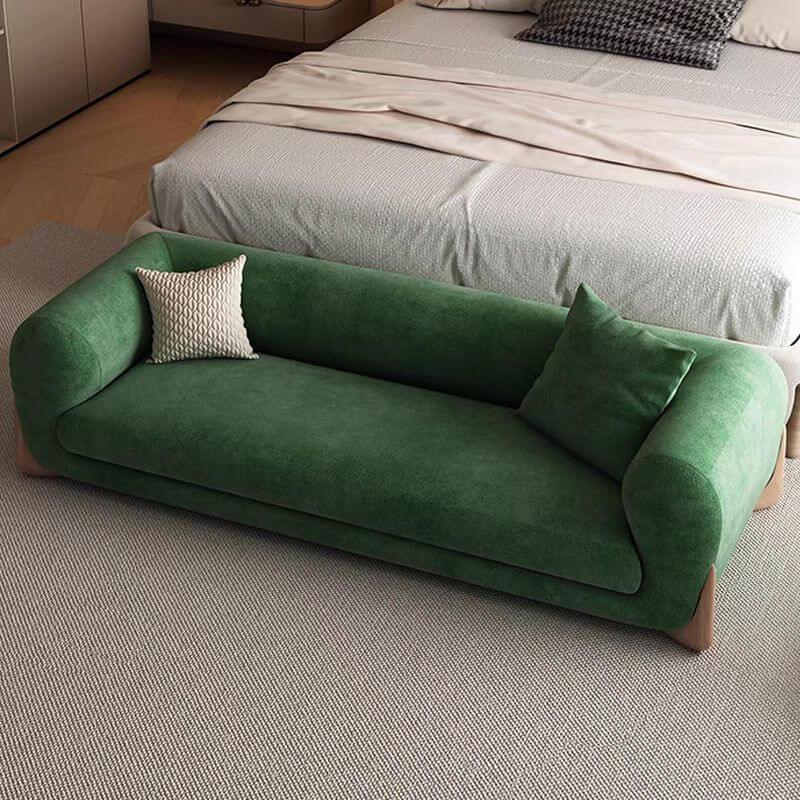 Close-up of cushion on solid color upholstered bench