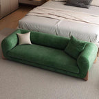 Close-up of cushion on solid color upholstered bench