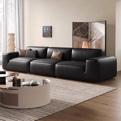 Comfortable black sofa with three pillows