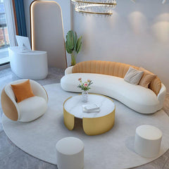 modern white curved sofa with pillows