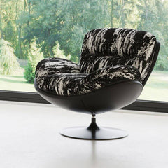 Beige and black abstract lounge chair in home setting