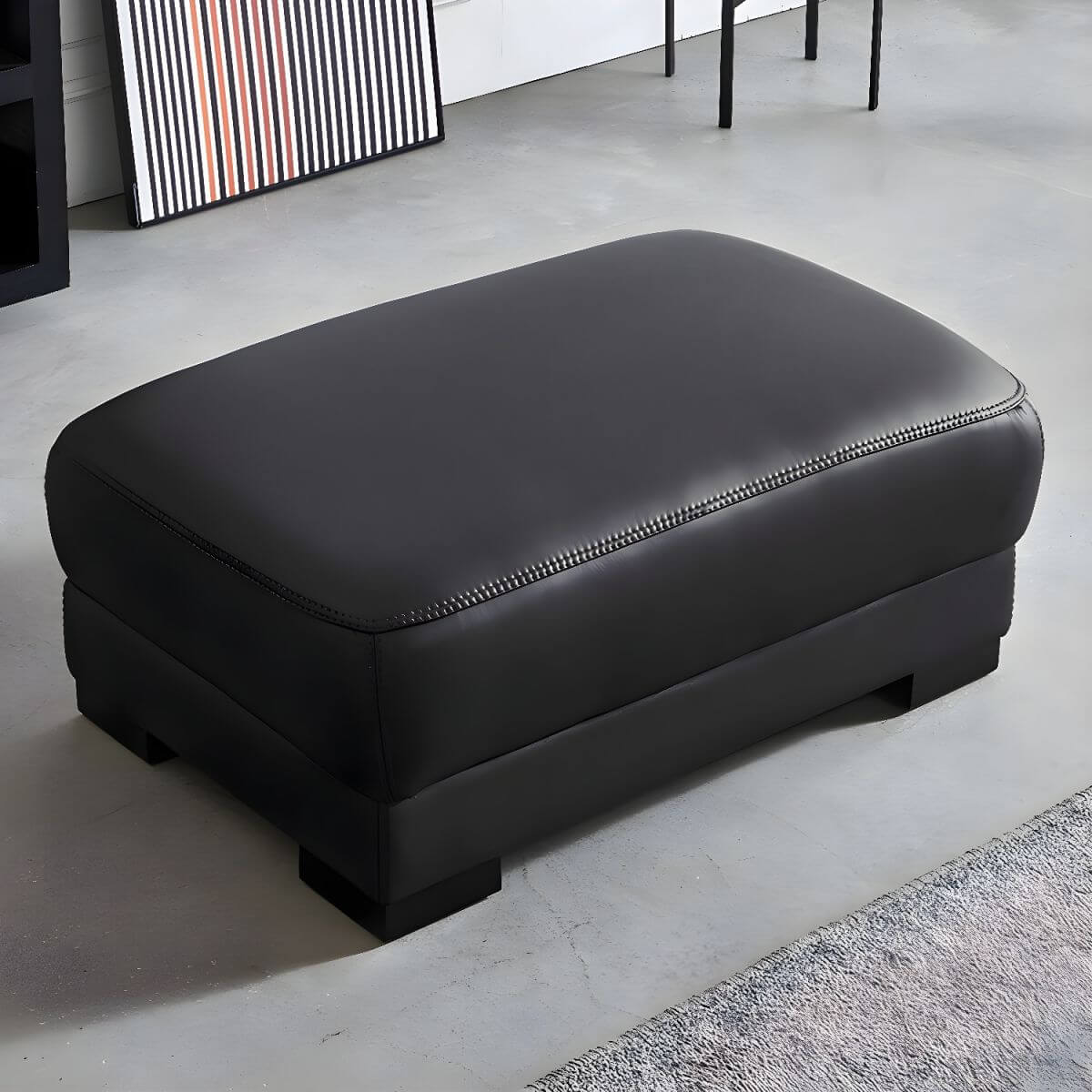 Upholstered modern accent stool in dark gray