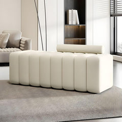 Upholstered beige ottoman in living room setting