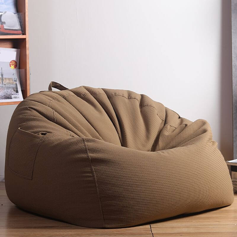 A versatile sack chair with armrests and built-in storage, resembling a modern bean bag.