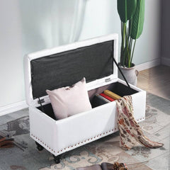 Green storage ottoman with nailhead trim