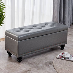 Green storage ottoman with nailhead trim