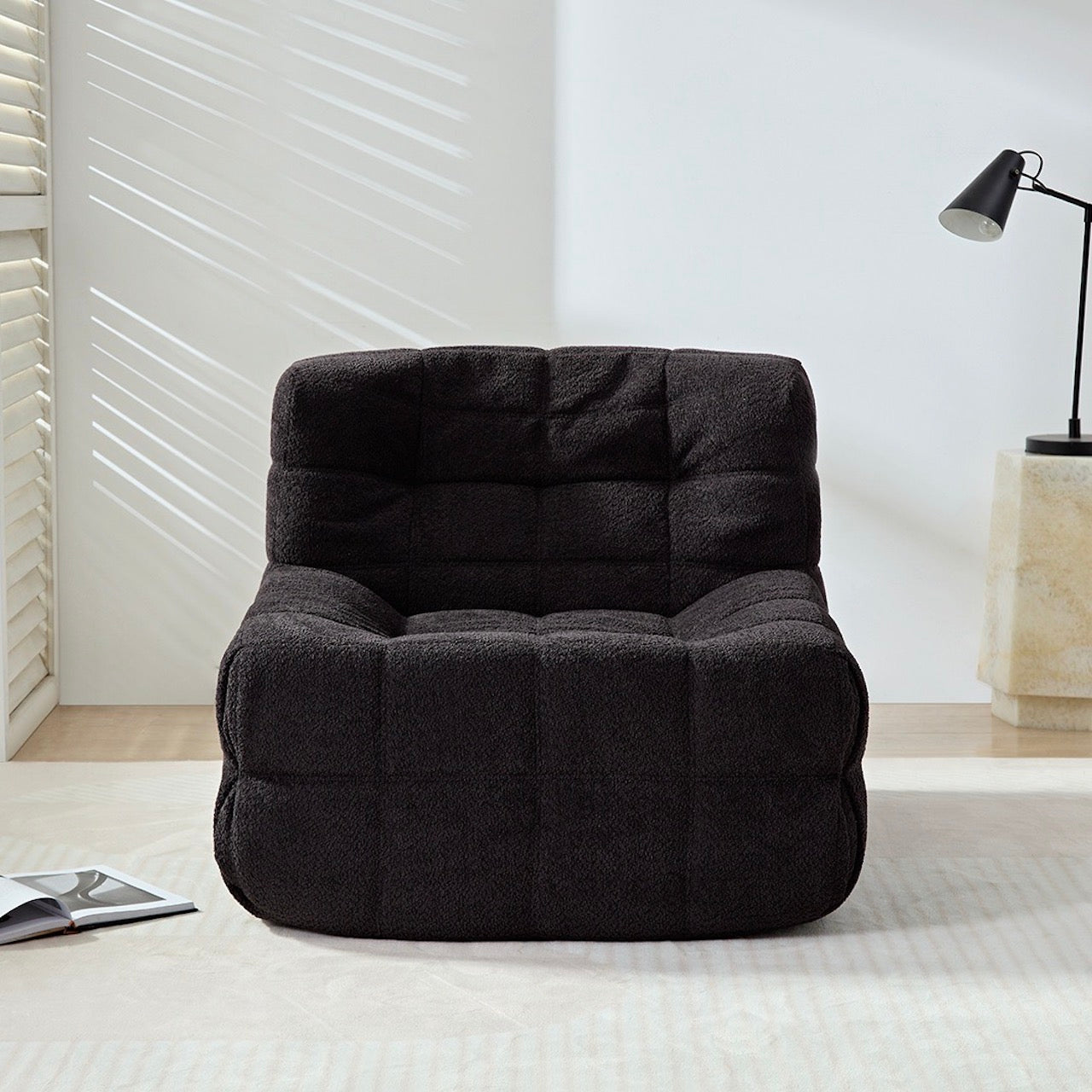Black corduroy vintage caterpillar lounge chair in a cozy living room setting