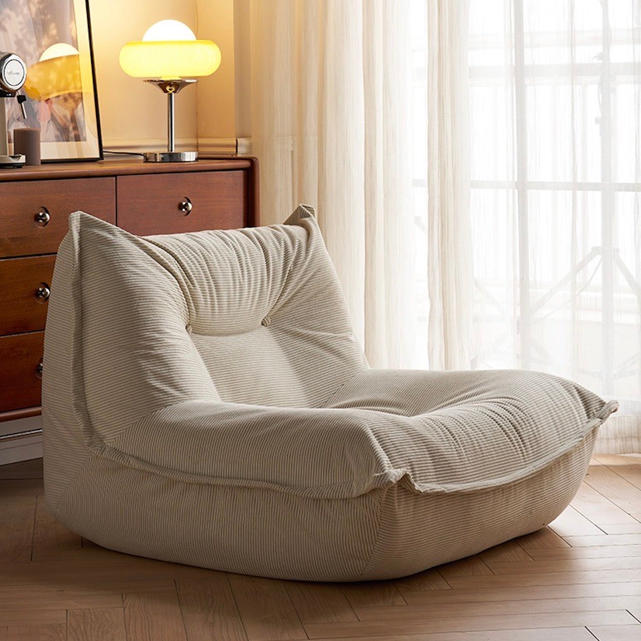 White Corduroy Caterpillar Lounge Chair in a cozy living room setting