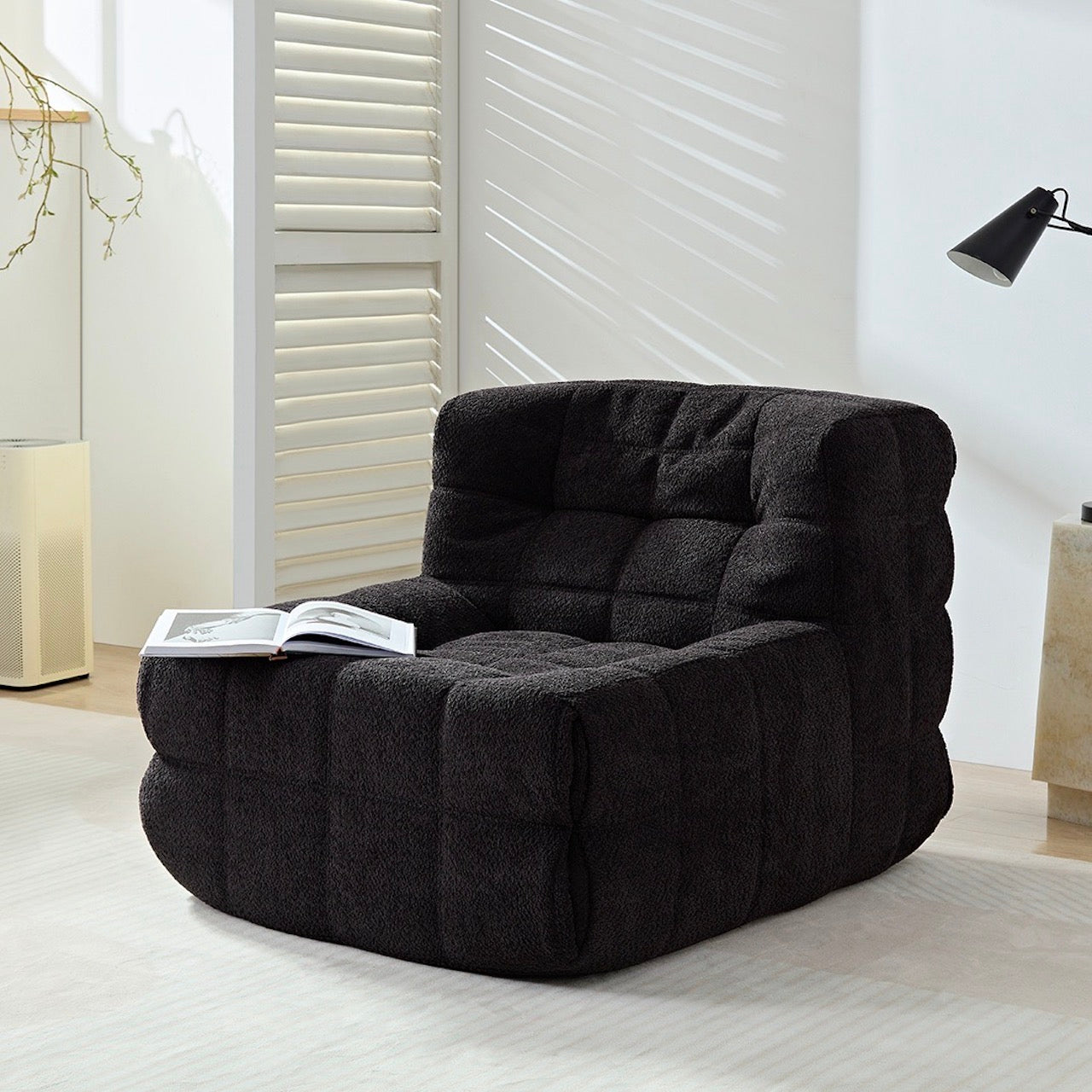 Black corduroy vintage caterpillar lounge chair in a cozy living room setting