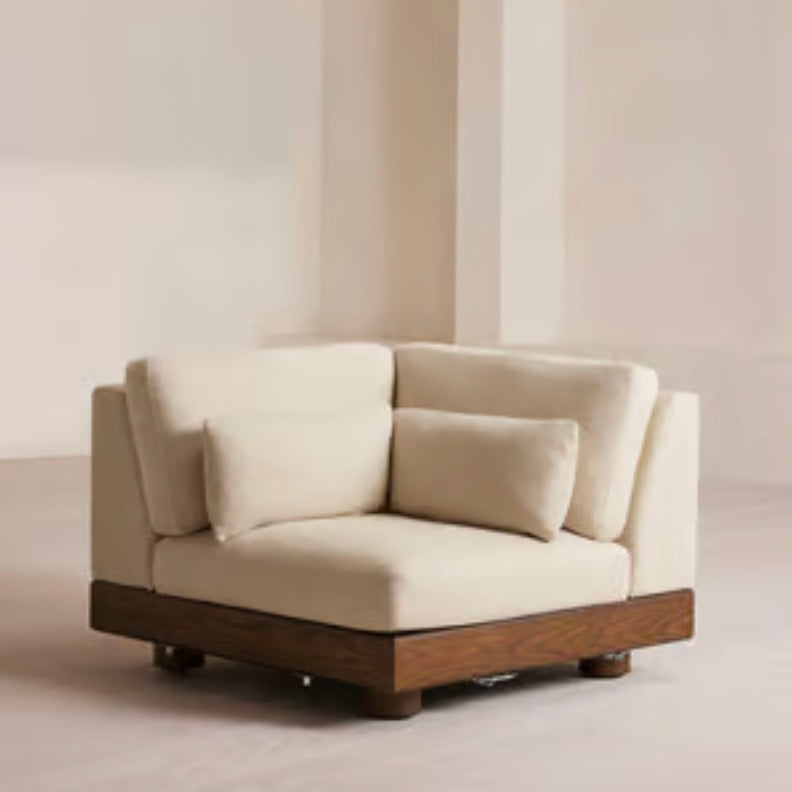 Cream Art Deco floor sofa with pillow back, pillow top arms, slipcover, and multiple pillows for seating 2 to 4 people