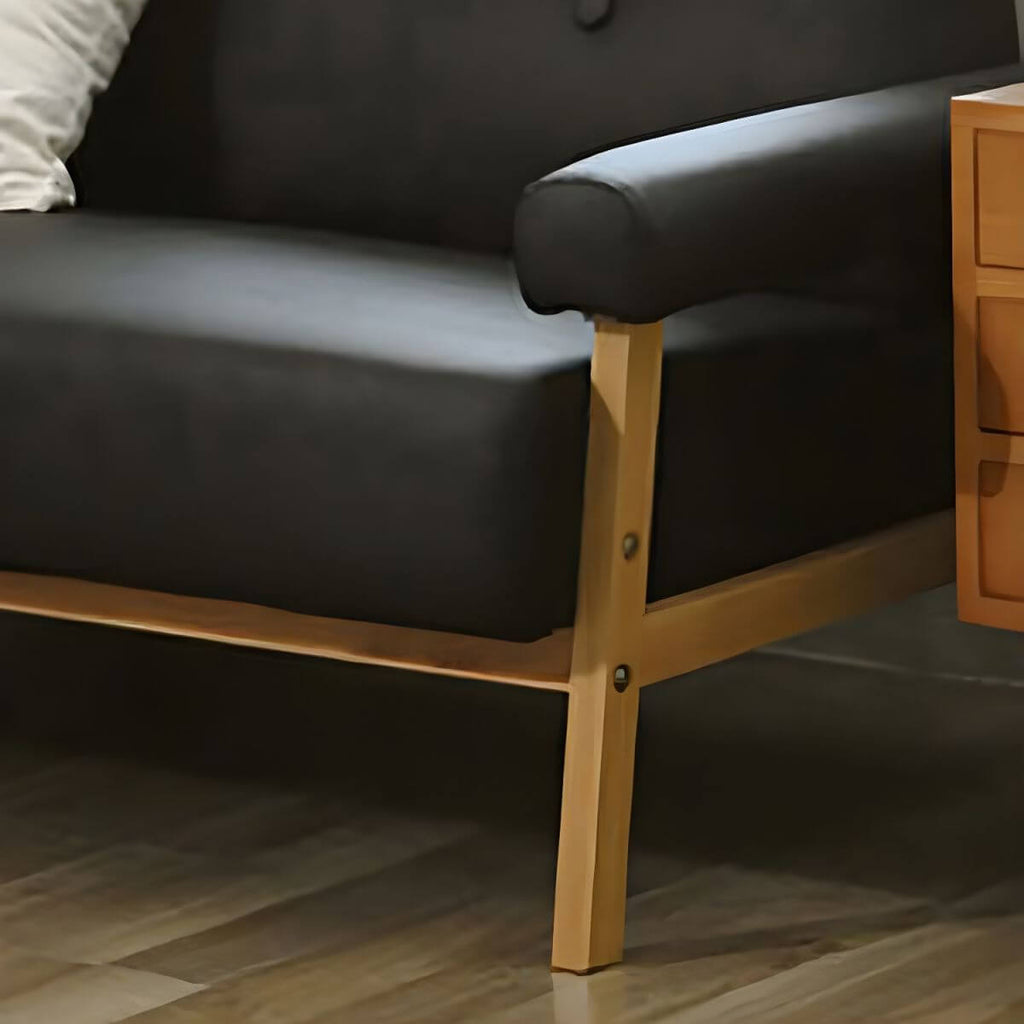 Black Scandinavian style small sofa with wood frame and faux leather upholstery